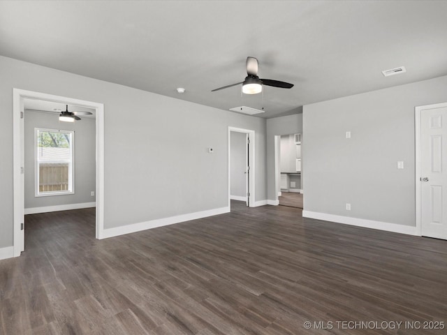 241 NE Debell Ave, Bartlesville, OK 74006 - unfurnished living room featuring ceiling fan, baseboards, and dark wood-style floors