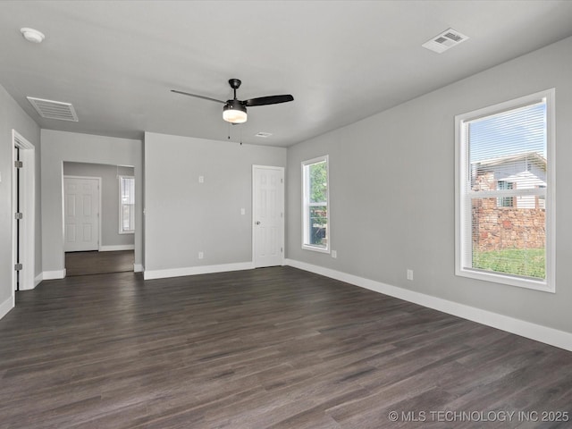 241 NE Debell Ave, Bartlesville, OK 74006 - unfurnished living room with ceiling fan, baseboards, and dark wood-style flooring