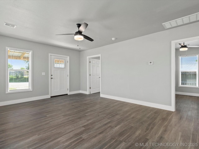 241 NE Debell Ave, Bartlesville, OK 74006 - unfurnished living room with a ceiling fan, dark wood-style flooring, and baseboards