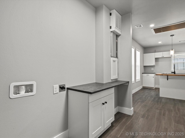 241 NE Debell Ave, Bartlesville, OK 74006 - laundry room with baseboards, dark wood-style flooring, and recessed lighting