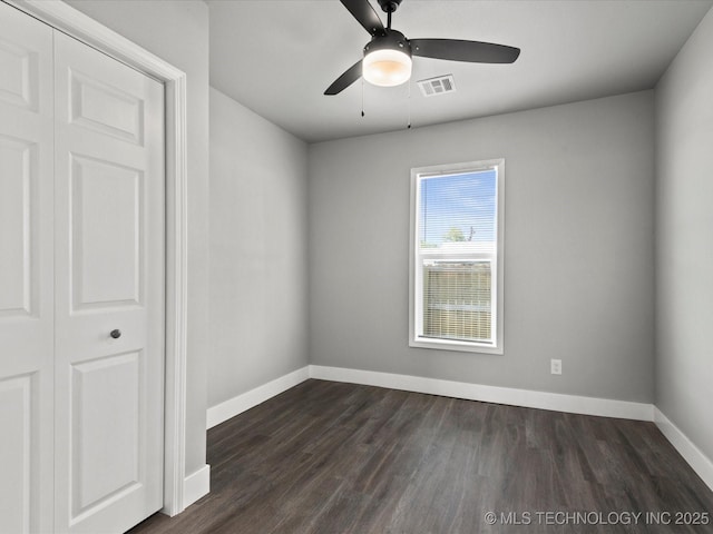 241 NE Debell Ave, Bartlesville, OK 74006 - spare room featuring baseboards, a ceiling fan, and dark wood-style flooring
