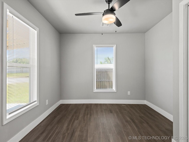 241 NE Debell Ave, Bartlesville, OK 74006 - unfurnished room featuring dark wood-style flooring, a ceiling fan, and baseboards