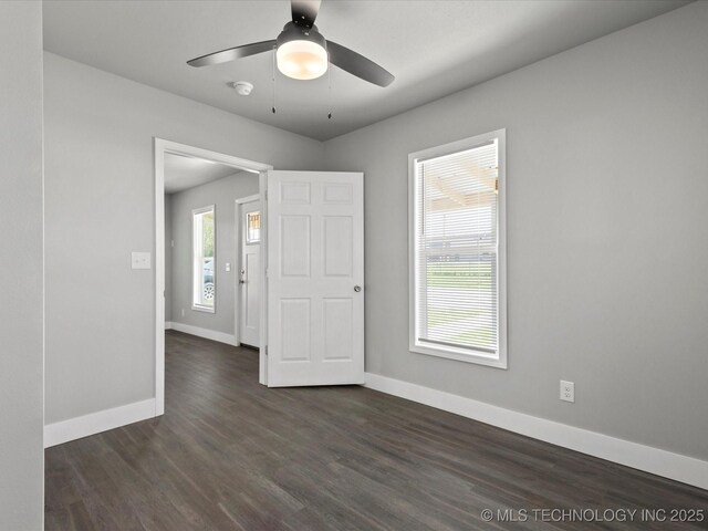 241 NE Debell Ave, Bartlesville, OK 74006 - empty room featuring a ceiling fan, baseboards, and dark wood-style flooring