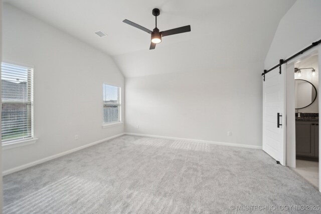 1305 N Dogwood Ave, Broken Arrow, OK 74012 - unfurnished bedroom with a barn door, lofted ceiling, carpet flooring, baseboards, and a ceiling fan