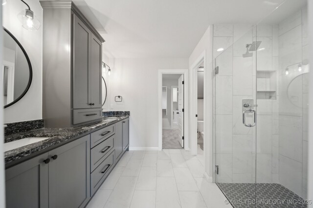 1305 N Dogwood Ave, Broken Arrow, OK 74012 - bathroom featuring double vanity, a shower stall, toilet, baseboards, and marble finish flooring