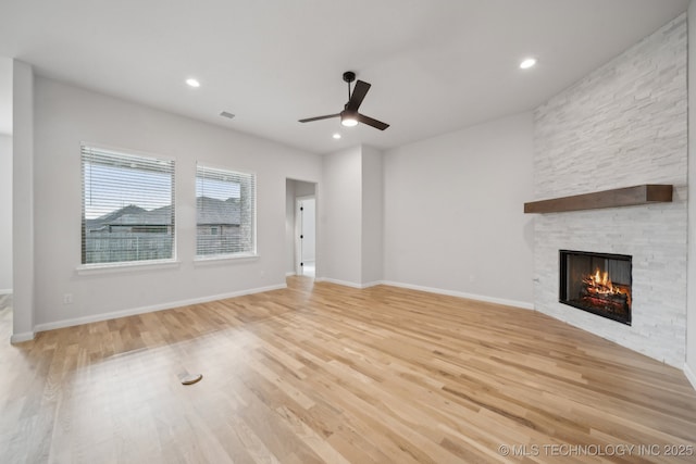 1305 N Dogwood Ave, Broken Arrow, OK 74012 - unfurnished living room featuring a stone fireplace, a ceiling fan, wood finished floors, baseboards, and recessed lighting