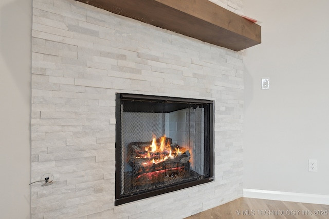 1305 N Dogwood Ave, Broken Arrow, OK 74012 - detailed view of a stone fireplace, baseboards, and wood finished floors