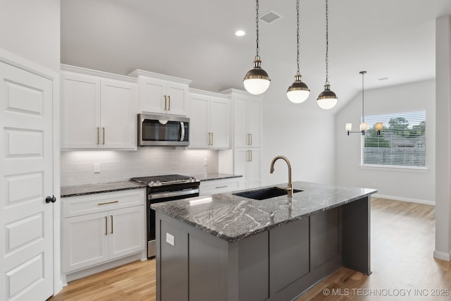 1305 N Dogwood Ave, Broken Arrow, OK 74012 - kitchen with appliances with stainless steel finishes, a sink, decorative backsplash, dark stone countertops, and white cabinetry