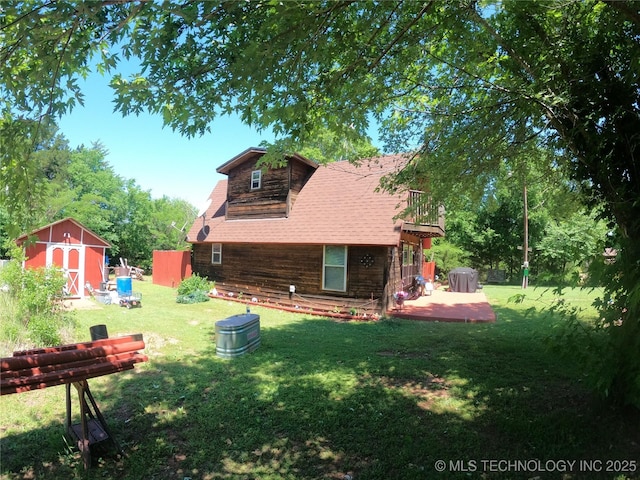 808 N Norfolk Rd, Yale, OK 74085 - back of property featuring a yard, a wooden deck, log exterior, and a shingled roof