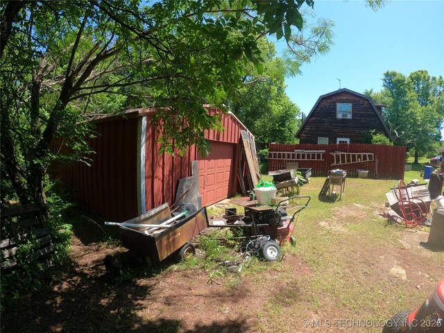 808 N Norfolk Rd, Yale, OK 74085 - view of green lawn featuring a detached garage and an outdoor structure