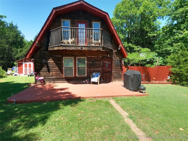 808 N Norfolk Rd, Yale, OK 74085 - rear view of property with a gambrel roof, a patio, and a balcony