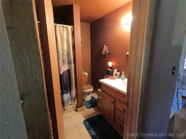 808 N Norfolk Rd, Yale, OK 74085 - bathroom featuring toilet, vanity, tile patterned flooring, and a shower with curtain