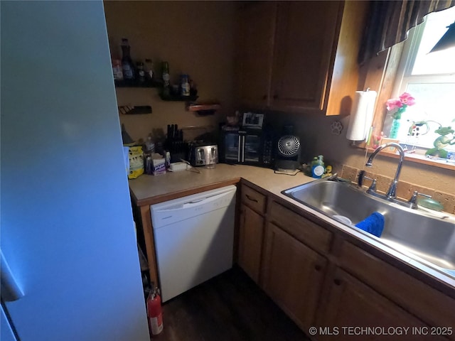 808 N Norfolk Rd, Yale, OK 74085 - kitchen with white dishwasher, a sink, and light countertops