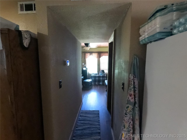 808 N Norfolk Rd, Yale, OK 74085 - corridor with a textured ceiling and wood finished floors