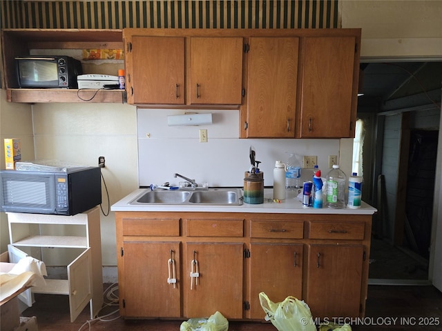 360 N 5th St, Fairfax, OK 74637 - kitchen featuring black microwave, a sink, light countertops, and brown cabinets