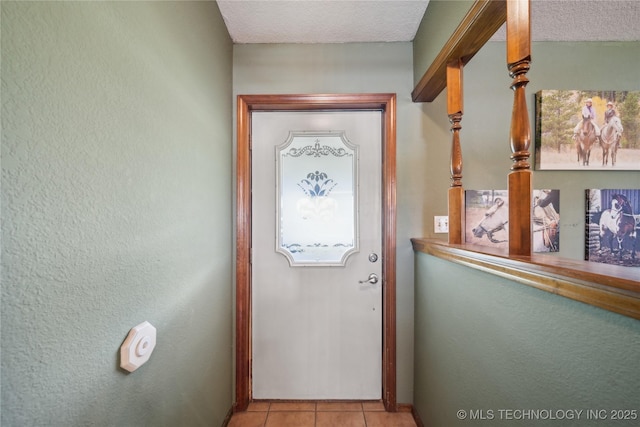 1202 S Oak Grove Rd, Cushing, OK 74023 - doorway to outside with light tile patterned flooring, baseboards, and a textured ceiling