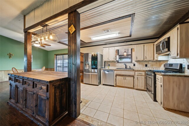 1202 S Oak Grove Rd, Cushing, OK 74023 - kitchen with stainless steel appliances, ceiling fan, a sink, wooden counters, and hanging light fixtures