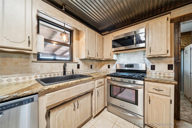 1202 S Oak Grove Rd, Cushing, OK 74023 - kitchen featuring stainless steel appliances, a sink, tasteful backsplash, light countertops, and light brown cabinets