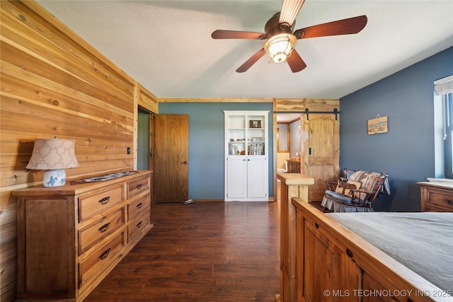 1202 S Oak Grove Rd, Cushing, OK 74023 - bedroom featuring dark wood-type flooring and wood walls