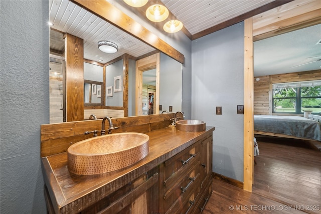 1202 S Oak Grove Rd, Cushing, OK 74023 - full bathroom with connected bathroom, wood-type flooring, double vanity, wood ceiling with exposed beams, and baseboards