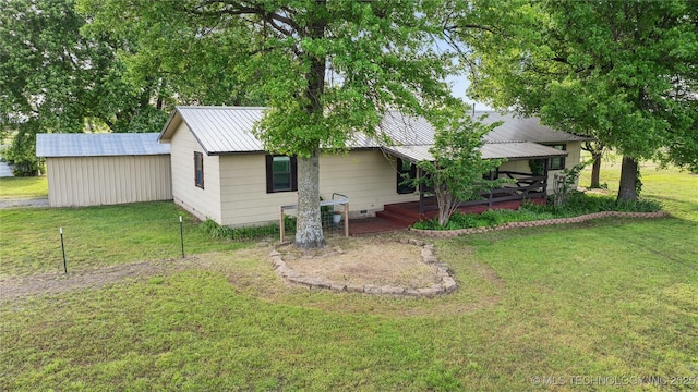 1202 S Oak Grove Rd, Cushing, OK 74023 - rear view of property featuring a lawn and metal roof