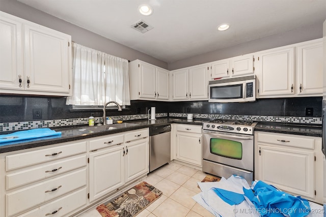 18268 S 79th E Ave, Bixby, OK 74008 - kitchen featuring appliances with stainless steel finishes, a sink, white cabinets, tasteful backsplash, and recessed lighting