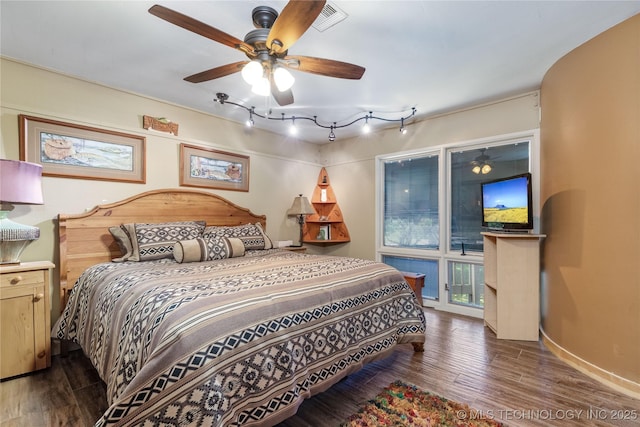 29898 S 566th Rd Unit 422, Afton, OK 74331 - bedroom featuring wood finished floors, rail lighting, ceiling fan, and baseboards