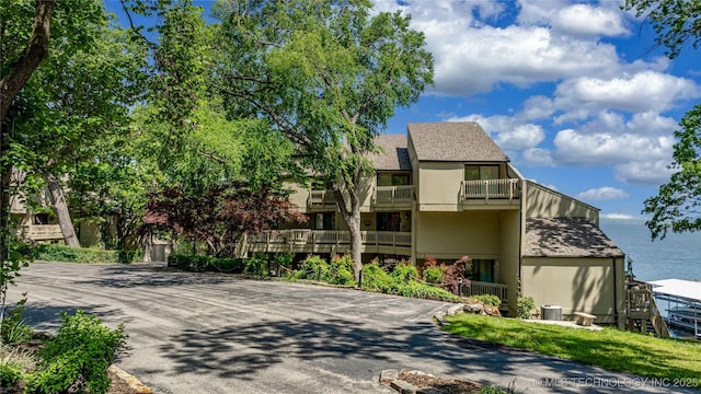 29898 S 566th Rd Unit 422, Afton, OK 74331 - view of front facade with a balcony and roof with shingles