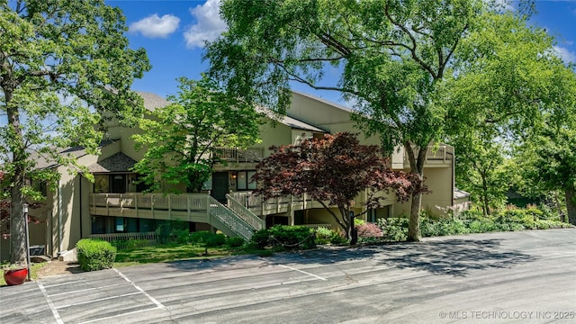 29898 S 566th Rd Unit 422, Afton, OK 74331 - view of building exterior featuring stairway and uncovered parking