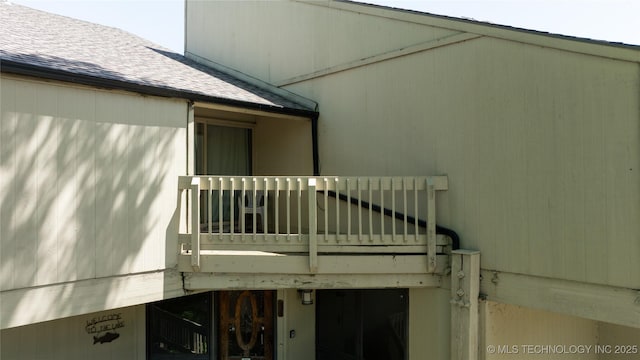 29898 S 566th Rd Unit 422, Afton, OK 74331 - doorway to property with roof with shingles and a balcony