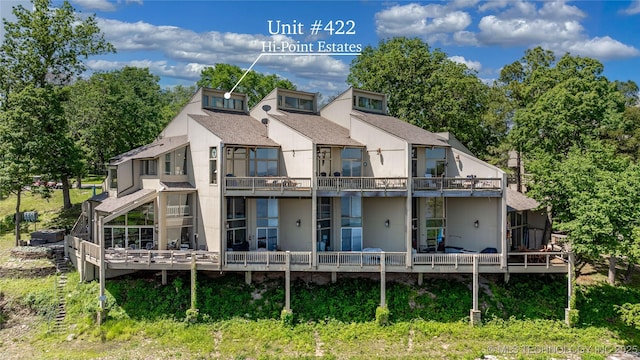 29898 S 566th Rd Unit 422, Afton, OK 74331 - rear view of property featuring stucco siding, a shingled roof, and a deck