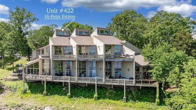 29898 S 566th Rd Unit 422, Afton, OK 74331 - back of house with a shingled roof, a wooden deck, and a balcony