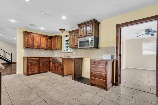 2382 Cheek, Lone Grove, OK 73443 - kitchen with stainless steel microwave, backsplash, light tile patterned flooring, a sink, and recessed lighting