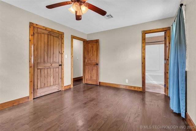 2382 Cheek, Lone Grove, OK 73443 - unfurnished bedroom with wood finished floors, baseboards, ceiling fan, and connected bathroom