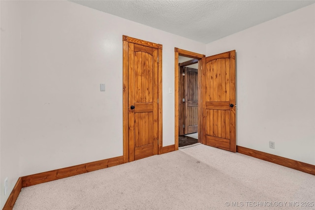 2382 Cheek, Lone Grove, OK 73443 - bedroom with carpet floors, baseboards, and a textured ceiling