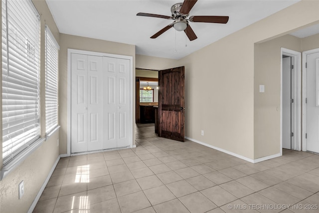 2382 Cheek, Lone Grove, OK 73443 - unfurnished bedroom featuring light tile patterned floors, baseboards, a closet, and a chandelier