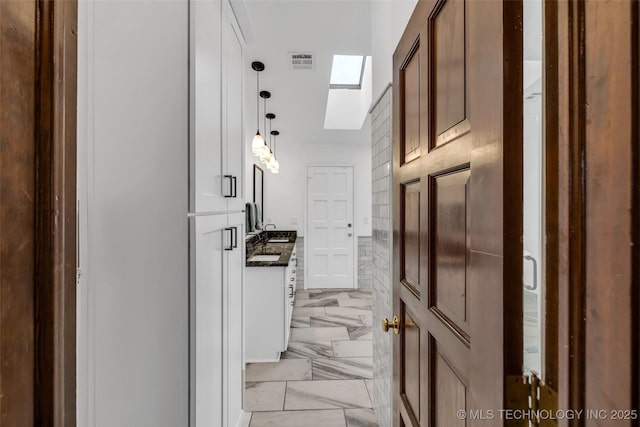 9417 S Gary Ave, Tulsa, OK 74137 - corridor with a skylight and light marble finish floors