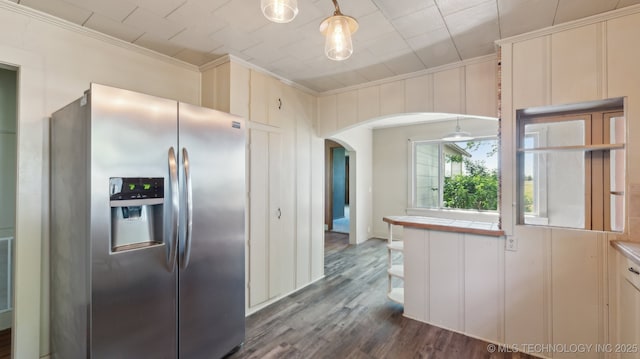 7941 N 433rd Rd, Adair, OK 74330 - kitchen featuring stainless steel fridge with ice dispenser, ornamental molding, arched walkways, dark wood finished floors, and tile counters