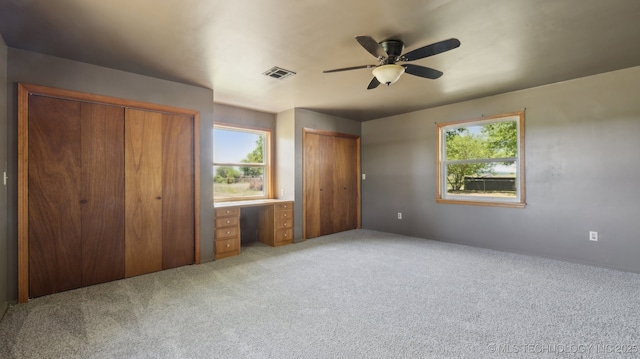 7941 N 433rd Rd, Adair, OK 74330 - unfurnished bedroom featuring two closets, carpet flooring, and ceiling fan
