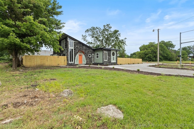 1550 E Apache St N, Tulsa, OK 74106 - view of front of home with stone siding and driveway