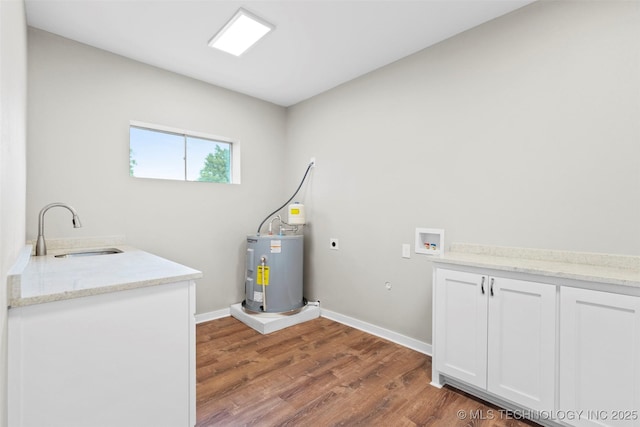 1550 E Apache St N, Tulsa, OK 74106 - laundry area with electric water heater, electric dryer hookup, wood finished floors, hookup for a washing machine, and cabinet space