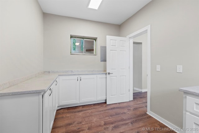 1550 E Apache St N, Tulsa, OK 74106 - kitchen featuring white cabinetry, dark wood-style floors, and baseboards
