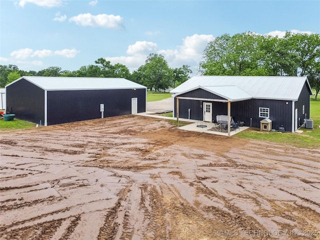 17784 S 210th Rd, Okmulgee, OK 74447 - back of house featuring an outbuilding, cooling unit, an outdoor structure, and a patio area
