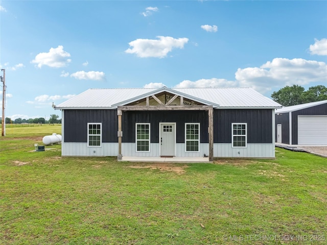 17784 S 210th Rd, Okmulgee, OK 74447 - view of front of house with a front yard, a detached garage, board and batten siding, and metal roof