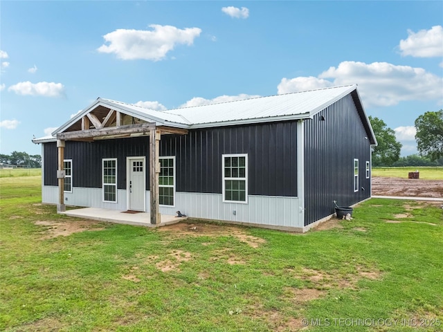 17784 S 210th Rd, Okmulgee, OK 74447 - back of house featuring a lawn, a patio area, and metal roof