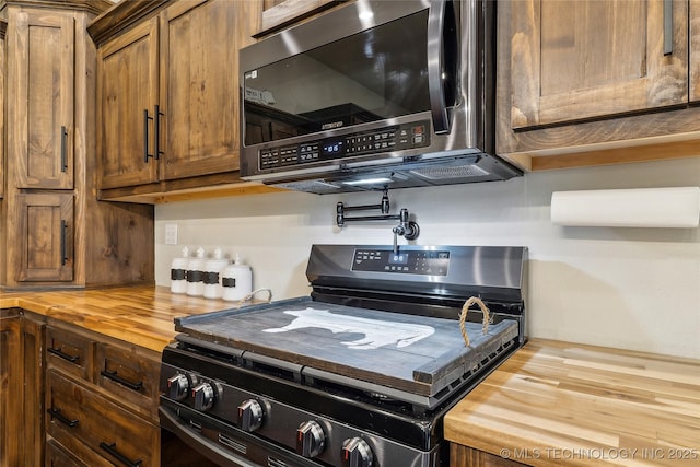 17784 S 210th Rd, Okmulgee, OK 74447 - kitchen with wooden counters, range with electric cooktop, and stainless steel microwave