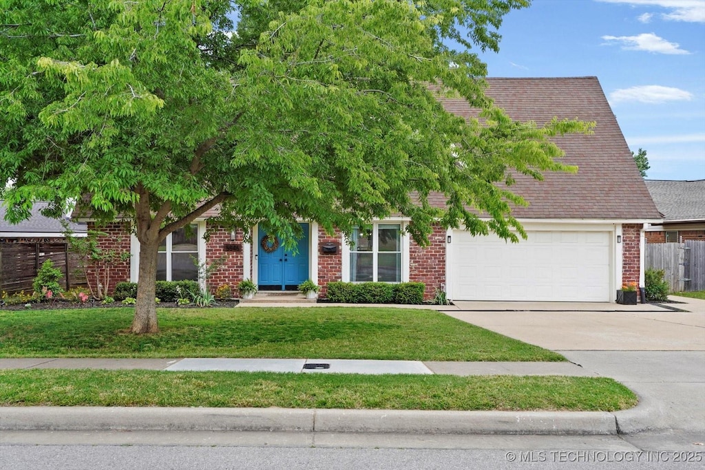 5846 S 76th E Ave, Tulsa, OK 74145 - obstructed view of property with concrete driveway, brick siding, and a garage