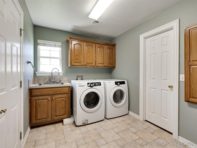 8704 N 140th E Ct, Owasso, OK 74055 - laundry room with cabinet space, washing machine and clothes dryer, and baseboards