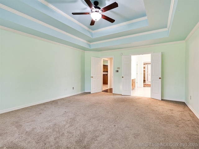 8704 N 140th E Ct, Owasso, OK 74055 - unfurnished bedroom with carpet floors, ornamental molding, a tray ceiling, baseboards, and ceiling fan