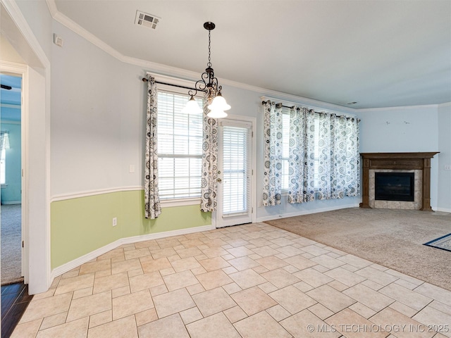 8704 N 140th E Ct, Owasso, OK 74055 - unfurnished living room with baseboards, plenty of natural light, ornamental molding, a glass covered fireplace, and carpet floors